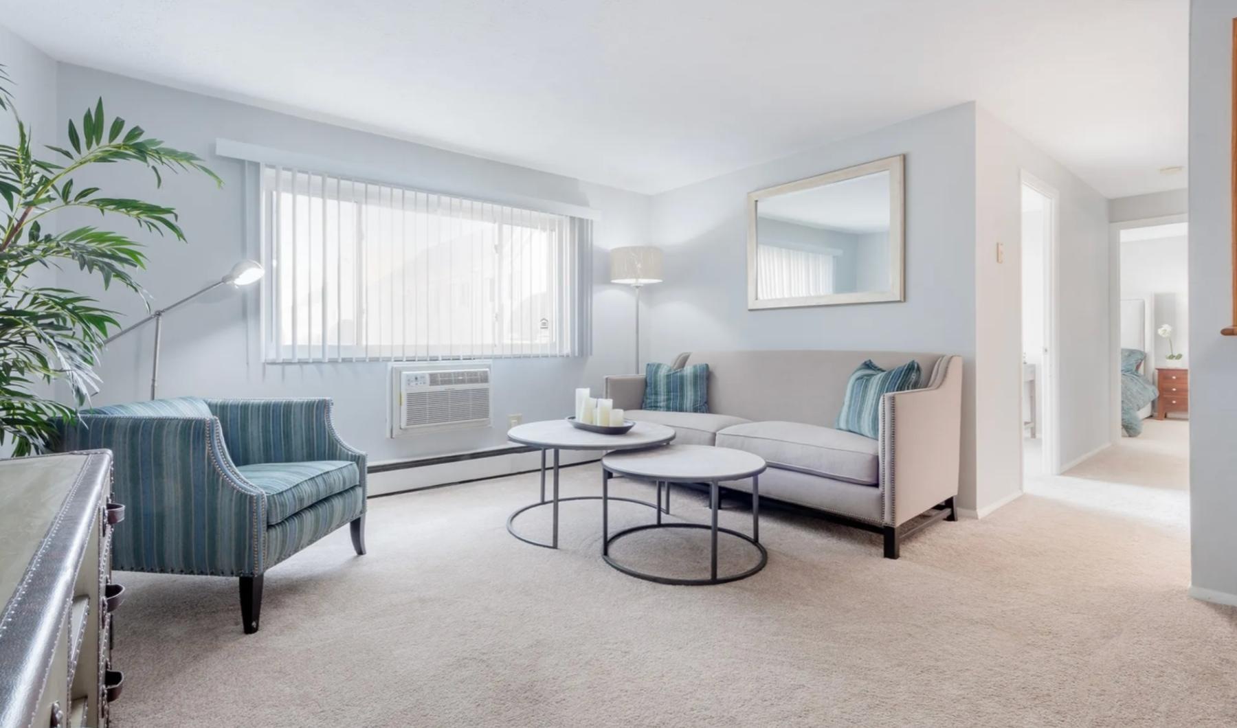 a living room with a couch chair and a table