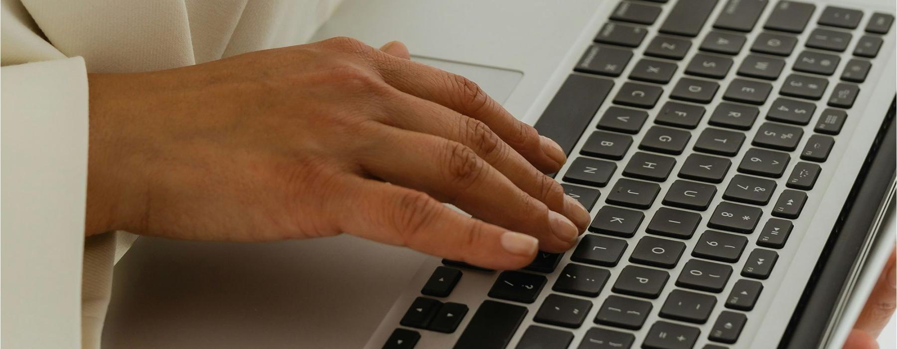 a person typing on a laptop