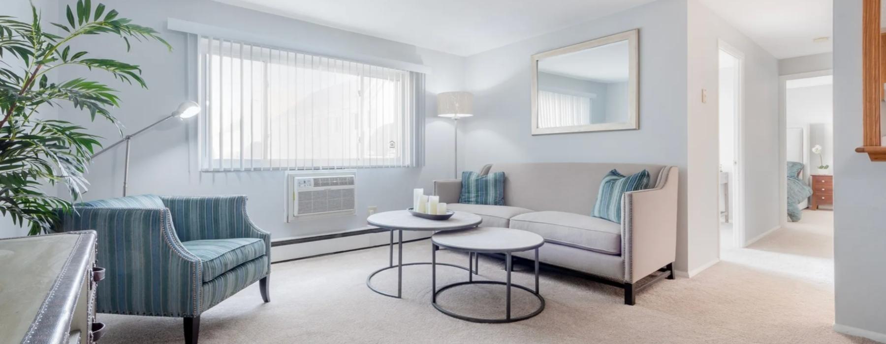 a living room with a couch chair and a table